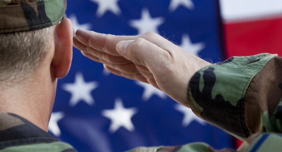 Soldier Saluting with USA flag in background
