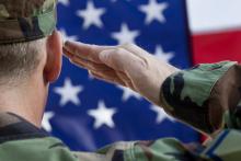 Soldier Saluting with USA flag in background